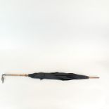 A hallmarked silver swan head handled partridge cane umbrella with glass eyes. L. 93cm.