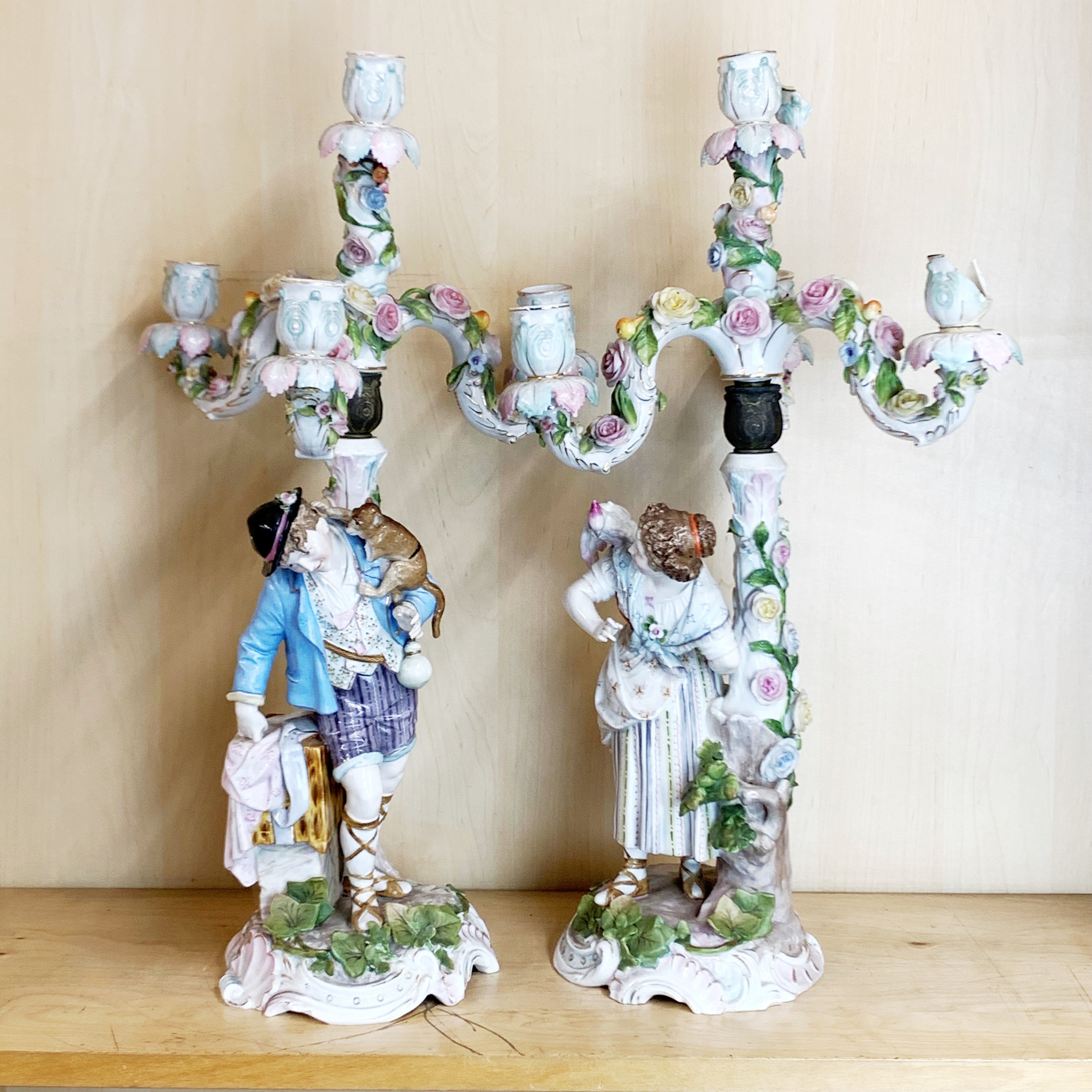 A pair of large 19th century hand-painted porcelain candelabras, H. 52cm. some damage, part of the