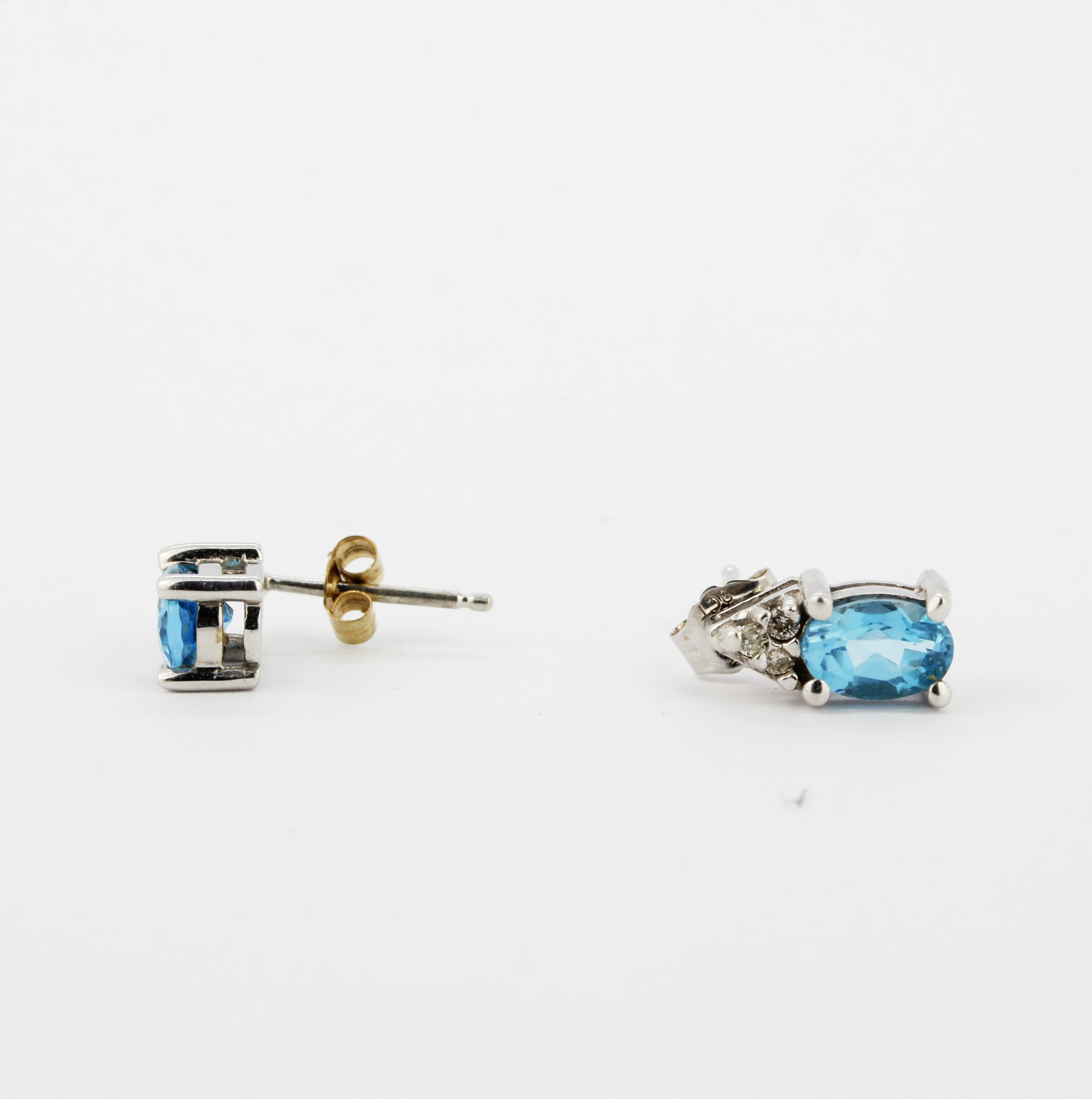 A pair of 9ct white gold stud earrings set with oval cut blue topaz and diamonds, L. 1cm. - Image 3 of 3