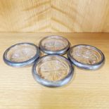 A set of four F. B. Rogers sterling silver rimmed glass coasters, Dia. 9.5cm.