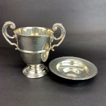 A two handled 1930's hallmarked silver trophy, H. 12cm. Together with a hallmarked silver armada