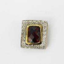 A hallmarked 9ct yellow and white gold pendant set with a rose cut garnet and small diamonds, L. 1.