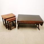 A drop leaf coffee table with burr walnut edging and plate glass top, extended 141 x 54 x 44cm