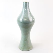 A celadon glazed heavily potted soft paste porcelain vase, probably Korean. H. 32cm.