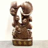 A large Chinese carved hardwood figure, H. 59cm. W. 27cm.