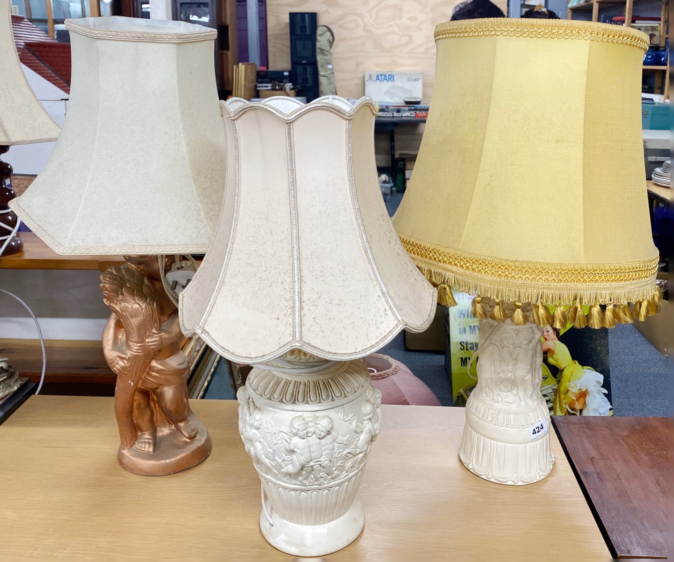 Three vintage plaster table lamps and shades, tallest H. 70cm.