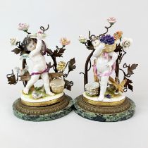 A lovely pair of German porcelain cherub figures with bronze tree decoration and marble bases, H.