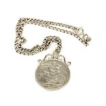 An 1889 silver crown mounted as a pendant with a heavy silver chain.
