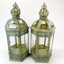 A pair of metal garden storm lanterns, H. 63cm.