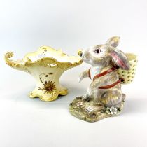 A soft paste porcelain figure of a rabbit with a basket, H. 19cm. together with a Limoges