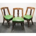 Three 19th century carved oak and green upholstered dining chairs.