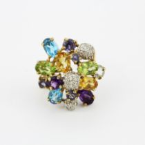 A hallmarked 9ct yellow gold ring set with citrines, amethysts, peridot, blue topaz, tanzanites
