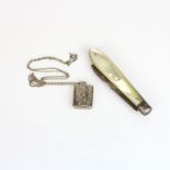 A mother of pearl and silver blade fruit knife with a silver locket and chain.
