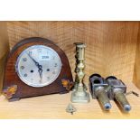 An oak mantel clock with a pair brass candlesticks and a pair of reproduction brass carriage