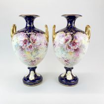 A pair of large 19th century Royal Bonn porcelain urns, H. 42cm. Some over gilding to handles.