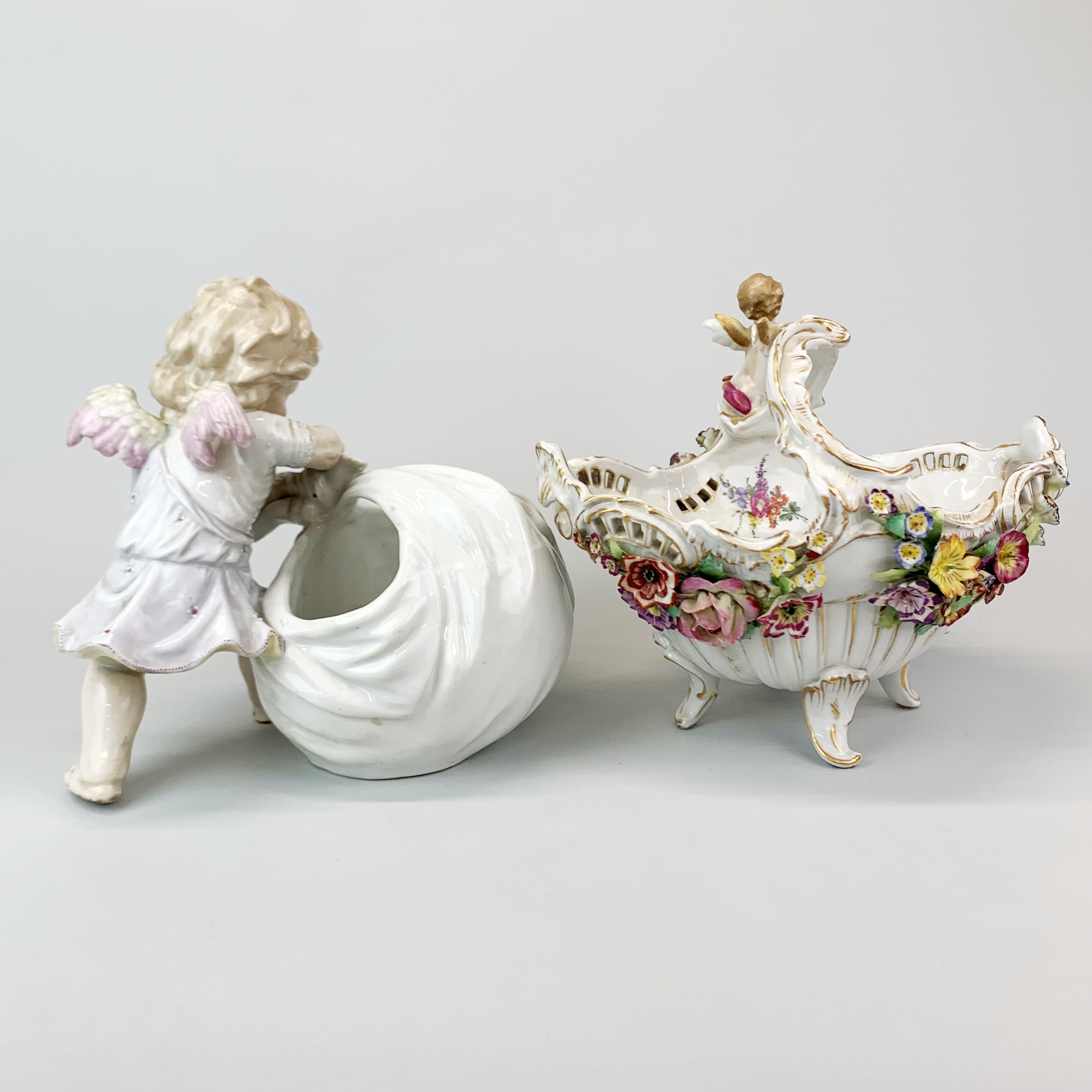 A 19th century German porcelain figure of a cherub with a basket, H. 21cm. together with a further - Image 3 of 3