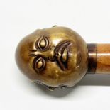 A bronze four face handle walking stick, L. 92cm.