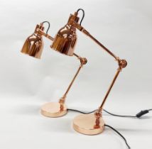 A pair of copper finish desk lamps.