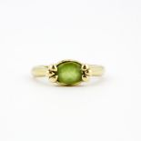 A hallmarked 9ct yellow gold peridot solitaire ring, (P).