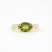A hallmarked 9ct yellow gold peridot solitaire ring, (P).