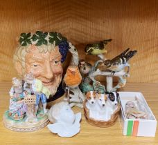 A Royal Doulton character jug together with a Doulton basket of dogs, a Goebel bird figure,