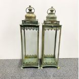 A pair of gilt metal and glass storm lanterns, H. 53cm.