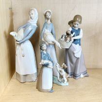 A group of four Lladro porcelain figures, tallest 26cm.