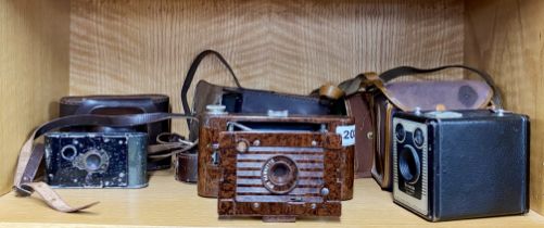 A brown Bakelite Hawkette number 2 folding camera and further cameras.