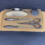 A cased silver manicure set.