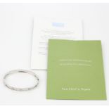 A Van Cleef & Arpels 18ct white gold bangle set with brilliant cut diamonds, inner W. 6cm. With