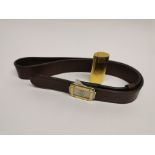 A Cartier gold plated lighter together with is Must de Cartier brown leather belt.