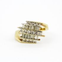 An unusual 14ct yellow gold (stamped 14K) ring set with brilliant and baguette cut diamonds,