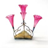 An early 20th century epergne with cranberry glass flutes, H. 30cm.