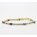 An 18ct yellow gold and platinum bracelet set with princess cut sapphires and diamonds, L. 18cm.