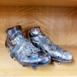A pair of silvered Puma football boots, L. 27cm.