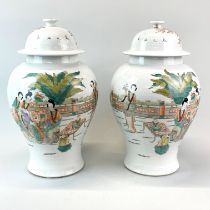 A pair of Chinese hand enamelled porcelain jars and covers, H. 40cm.