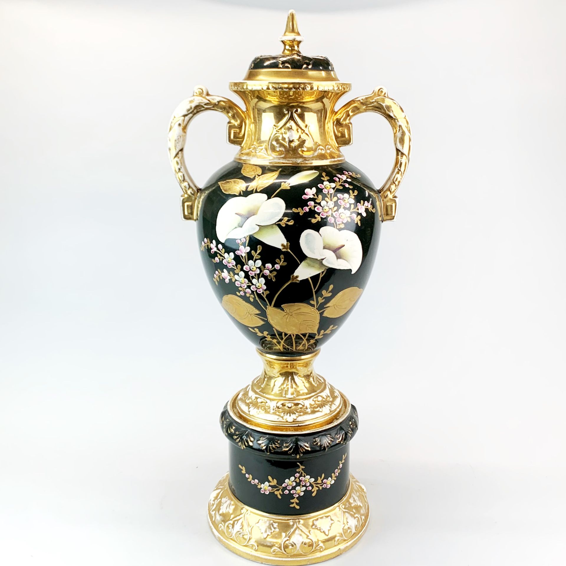 A large 19th century hand painted and gilt soft paste porcelain urn and cover, H. 68cm.