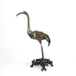 A lovely Chinese gilt and stone set silver figure of a crane mounted on a later base, H. 25cm.