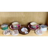 A group of 19th century Prattware pot lids with two cups and saucers.