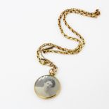 An antique hallmarked 9ct gold photo pendant, L. 4.2cm, on a yellow metal chain.