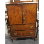 An early 20th century flame mahogany veneered drinks cabinet, 125 x 75 x 48cm. Missing shelves.