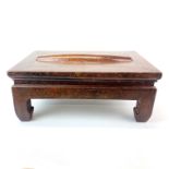 A mid-20th century Chinese hardwood foot massage table with rolling centre, 42 x 28 x 17cm.