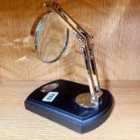 An adjustable desk magnifying glass, 18 x 14cm.