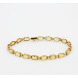 A 10ct yellow gold (stamped 10K) bracelet set with citrines and diamonds, L. 19.5cm.