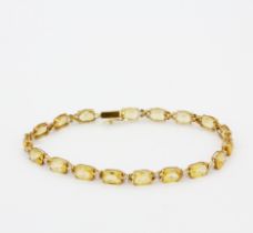 A 10ct yellow gold (stamped 10K) bracelet set with citrines and diamonds, L. 19.5cm.