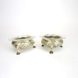 A pair of hallmarked silver salts with fluted glass liners.