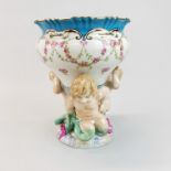 A continental porcelain vase being supported by young mermaids, H. 25cm.