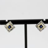 A pair of 18ct yellow and white gold (stamped 750) sapphire and diamond set earrings, L. 0.9cm.