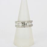 An 18ct white gold ring set with baguette and brilliant cut diamonds, approx. 2ct total, (N).