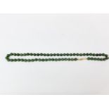 A dark green jade necklace, bead size 8mm, necklace L. 56mm.